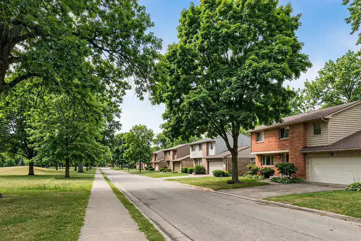 Suburban street near a park with mature trees in Bettendorf, IA